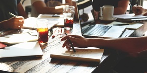 Close up of table with notebooks and a laptop